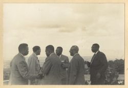 President William V. S. Tubman and others stand together and shake hands