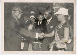 President William V. S. Tubman shakes hands with a woman wearing the Humane Order of African Redemption