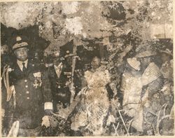 President William V. S. Tubman and Mrs. Tubman walk with military officials