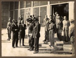 Portrait of President Tubman engaged in outdoor discussions with dignitaries