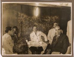 President Tubman and dignitaries sit around a small table