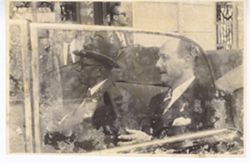 President William V. S. Tubman and an official sit in the back seat of a car