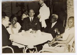 Dignitaries seated at small table