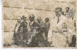 President William V. S. Tubman walks with officials