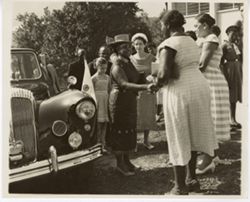 Mrs. Tubman greets women outside as others look on