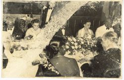 Group in formal attire seated during dinner party