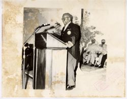 President William V. S. Tubman stands at podium and speaks