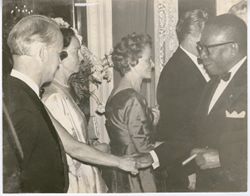 President William V. S. Tubman shakes hand with woman in line at reception