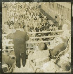Dignitary speaks to a crowd from a balcony