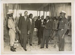 Officials and President William V. S. Tubman enter guarded building