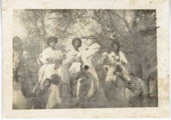 Men a top camels gather