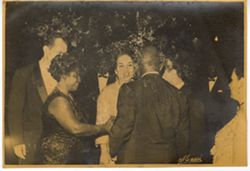 Guests mingling at dinner party together