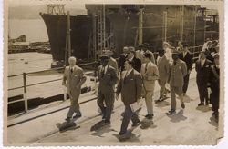 President Tubman walking with officials at shipyards