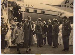 Woman and Coocoo Tubman disembarking from airplane