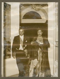 Couple in formal attire stand in doorway