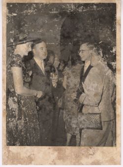 Two couples speaking at reception