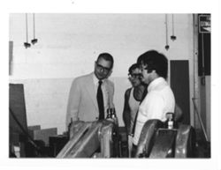 Versailles factory: examining machinery