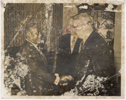 Officials greet each other during a reception