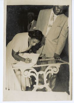 First Lady Antoinette Tubman signing book
