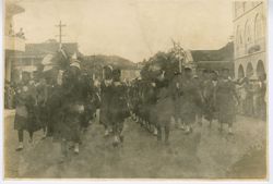 Young girls in uniform marching down the street during a parade