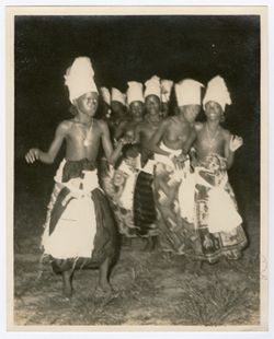 Young children in traditional attire dance