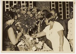 Mrs. Tubman looks at flowers with guests at an event