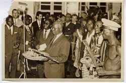 Dignitaries and men in traditional dress join in celebration