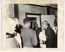 President William V. S. Tubman shakes hand with man while surrounded by guests