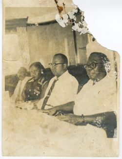 President William V. S. Tubman and Vice President William R. Tolbert sit with guests during a picnic