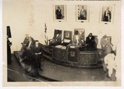 Government officials seated at platform in offical government meeting
