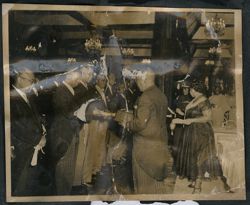 President Tubman hands a dignitary a document in the Executive Parlors