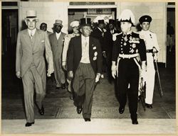 Prime Minister Bustamente, President William V. S. Tubman and Governor Sir Hugh Foot in formal attire leave facility