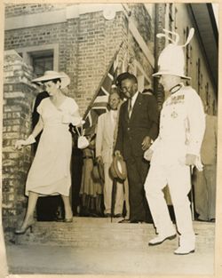 President William V. S. Tubman exits building with guests
