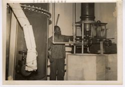 Man inspecting distilling aparatus