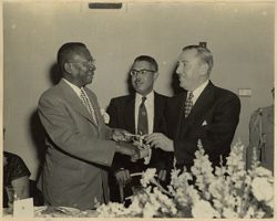 Mayor D'Alesandro presents President William V. S. Tubman with the key to Baltimore as Martin D. Jenkins looks on