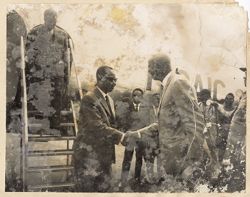 Officials greet each other as exit the airplane
