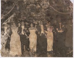 President William V. S. Tubman walks arm in arm with other dignitaries at a formal event
