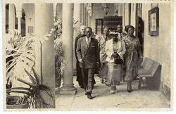 President and Mrs. Tubman walk along the edge of a courtyard in or near Seville, Spain