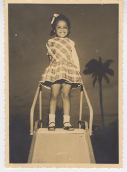 Young girl poses at the top of a slide