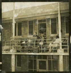 Dignitary stands behind a lectern on a balcony