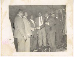 President William V. S. Tubman shakes hand of man standing in line