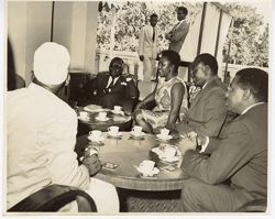 President William V. S. Tubman sits with group around small tables