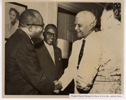 Brigadier General Benjamin O. Davis and Mrs. Davis shake hands with others