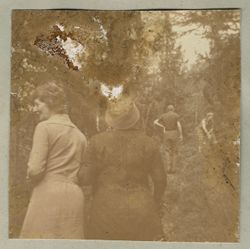 Women walk along a path in the woods