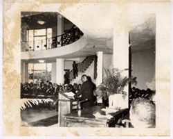 President William V. S. Tubman stands at podium and speaks in front of audience