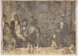 President Tubman watches as dinner companion greets musician