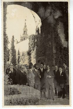 President Tubman and other dignitaries stand beneath an archway