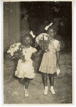 President Tubman's daughter, Coocoo, and friend Banke King hold flowers
