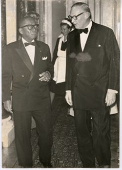 President William V. S. Tubman walks with Swedish banker in formal dress