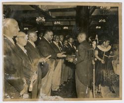 President Tubman hands a dignitary a scroll